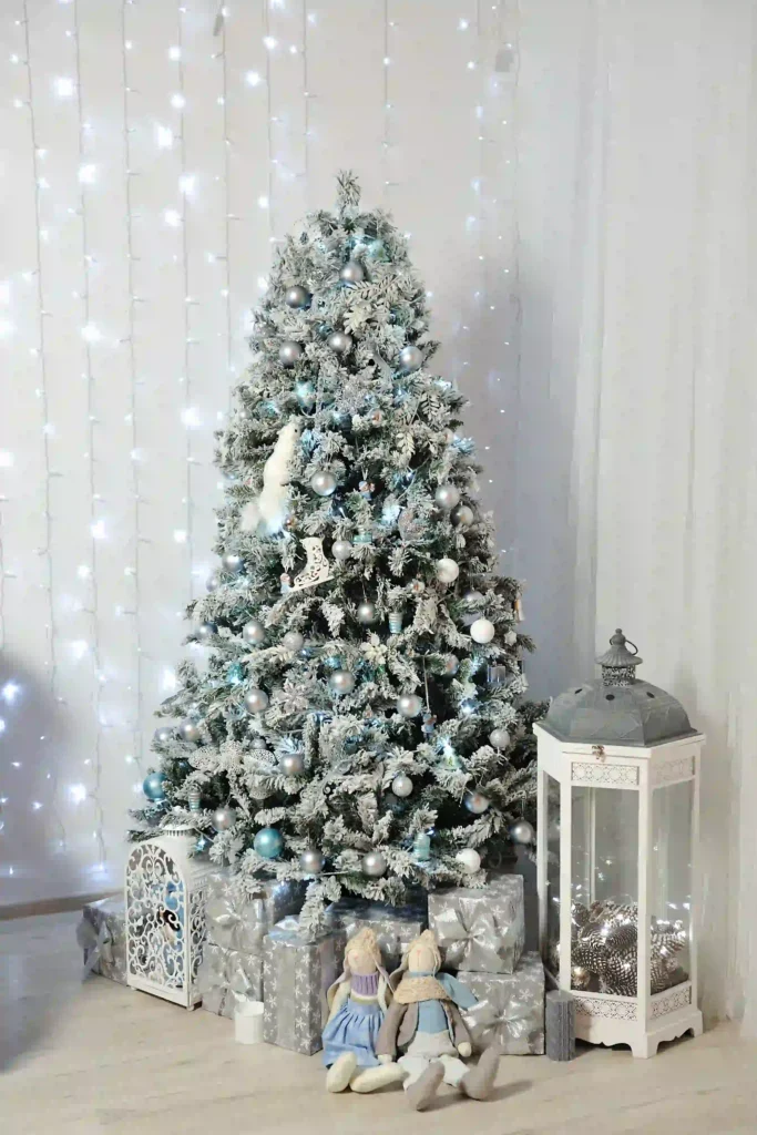 Flocked Christmas Tree Decorating Ideas in a cozy home with warm white lights and minimal ornaments