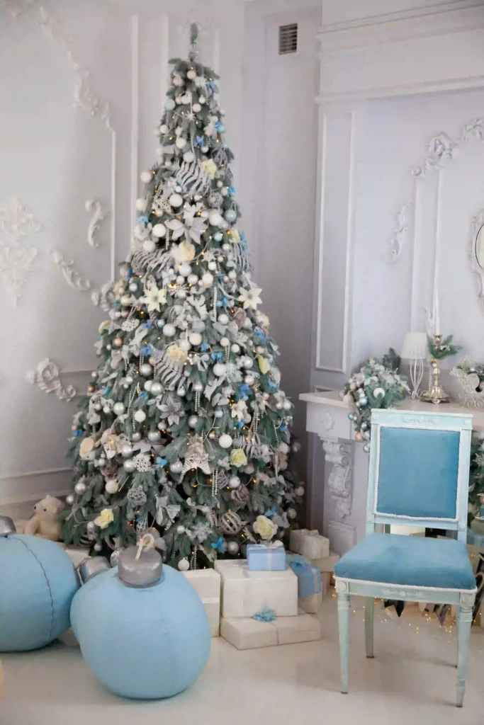 Flocked Christmas Tree Decorating Ideas with silver and icy blue ornaments in a winter wonderland theme