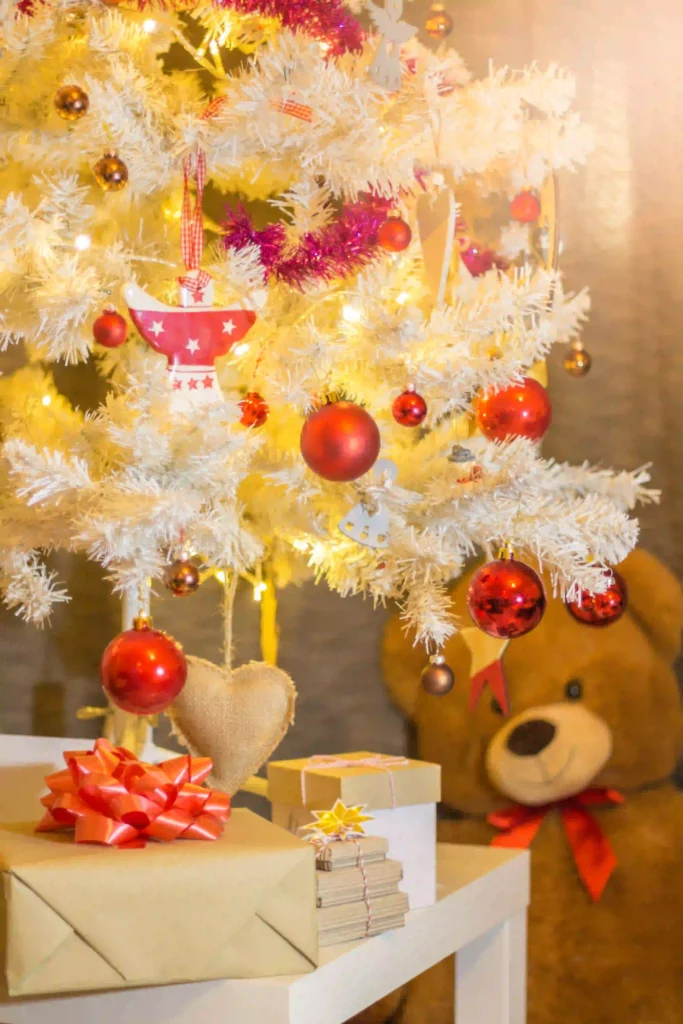 Flocked Christmas Tree Decorating Ideas with rustic farmhouse style using pinecones, wooden ornaments, and burlap ribbons