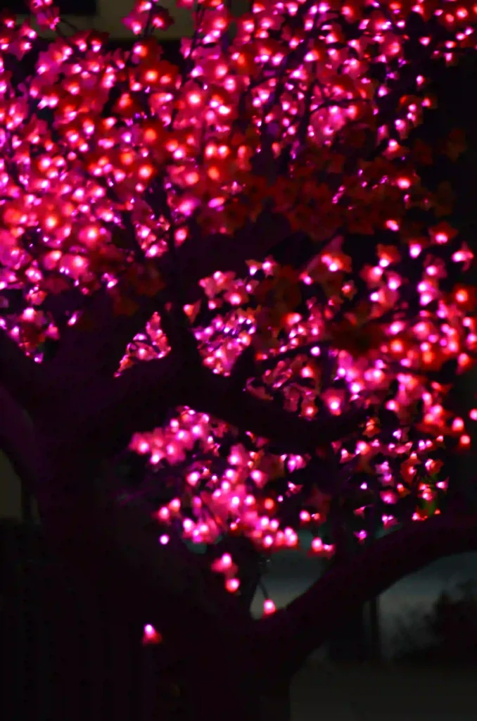 pink Christmas wreath with lights and ornaments