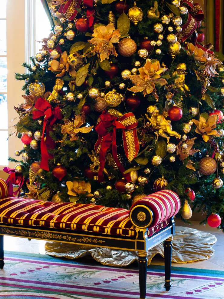 Fall Christmas Tree Ideas decorated with autumn leaves, burnt orange, mustard, and copper ornaments