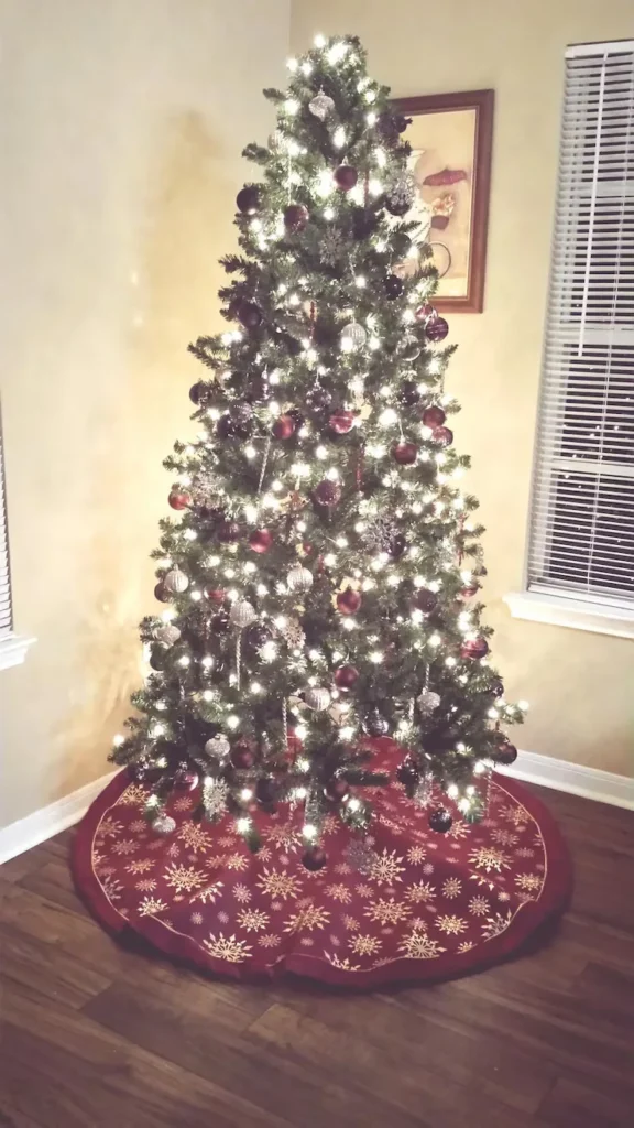 small vintage Christmas tree decorated with retro ornaments and warm lights